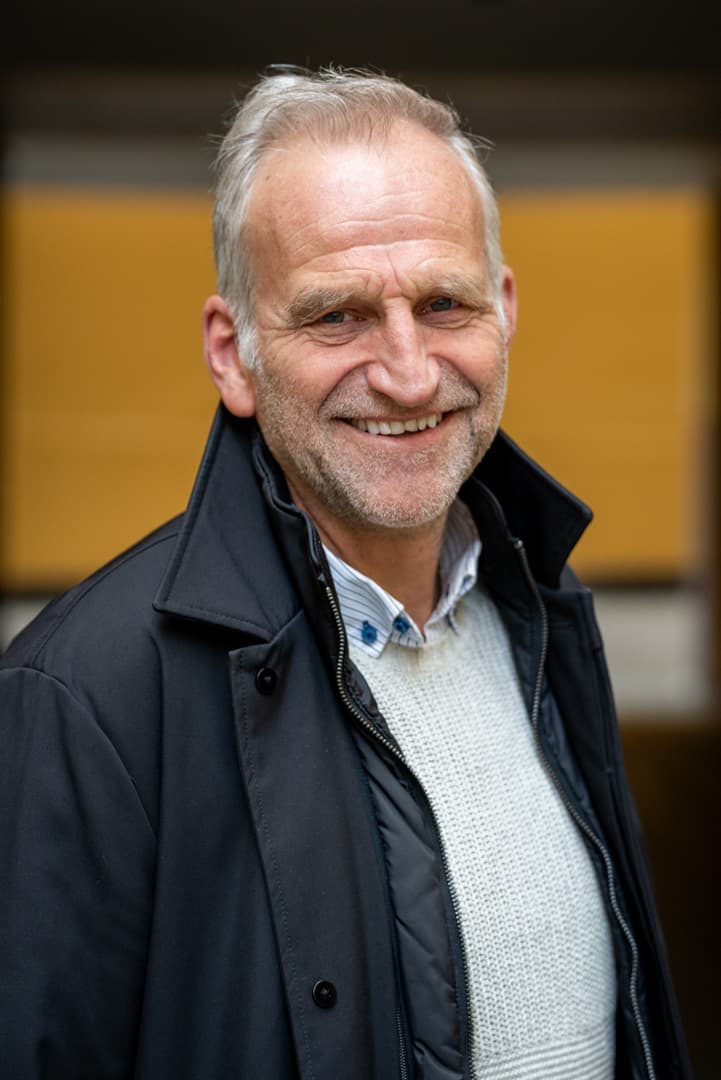 Hasle ser inn i kameraet og smiler.